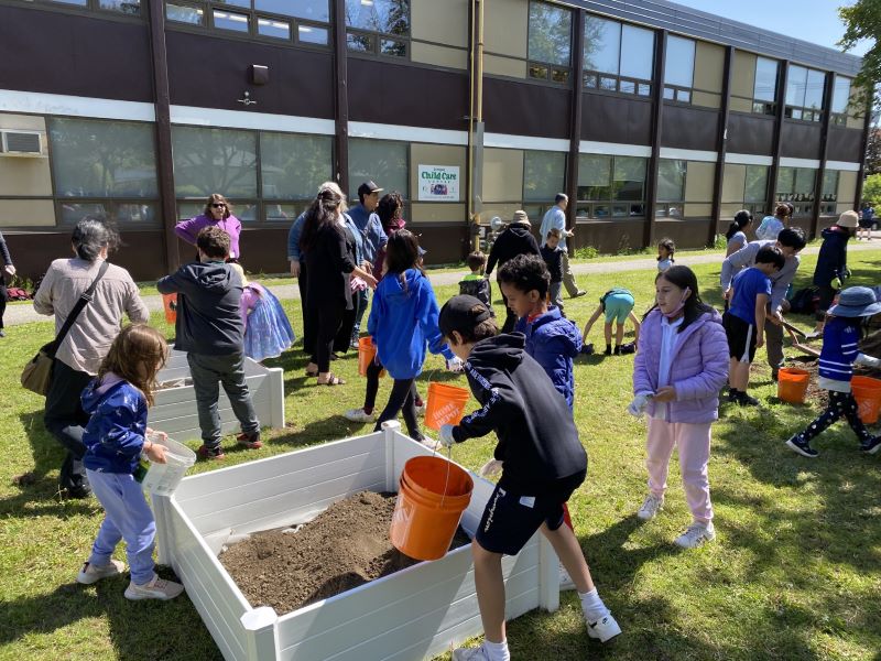 Pouring soil to the tiny gardens. Open Gallery