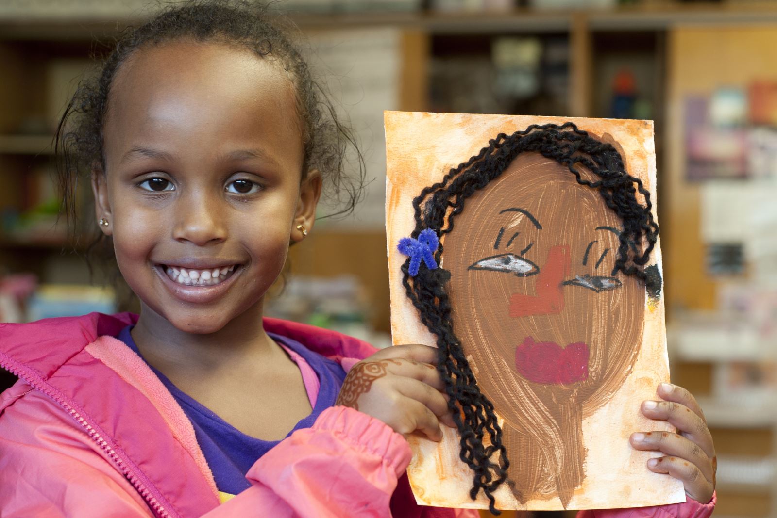 student holding artwork