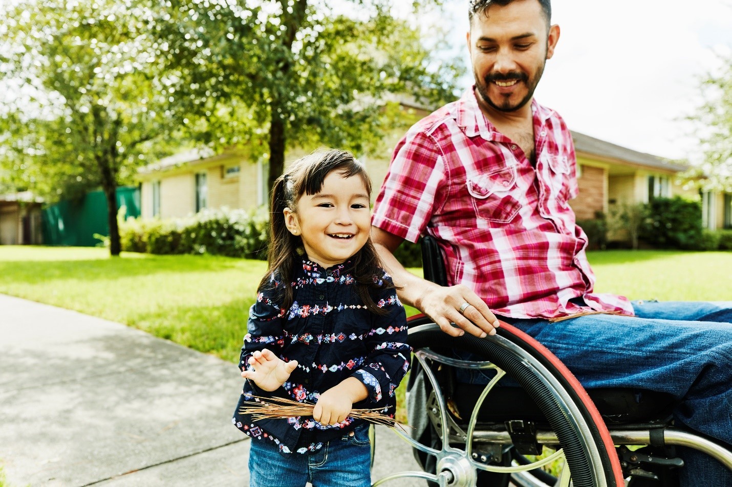 parent in wheelchair next to young student