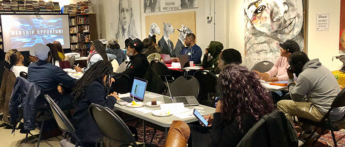 picture of a group of potential partners sitting around a table completing the application process