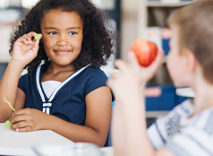 Two children enjoying a healthy snack