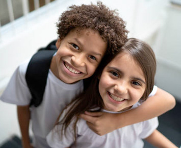 Two students smiling