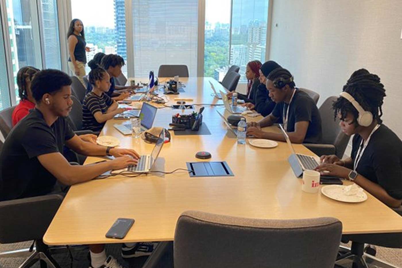 Students sit at table working as part of the Black Student Summer Leadership Program