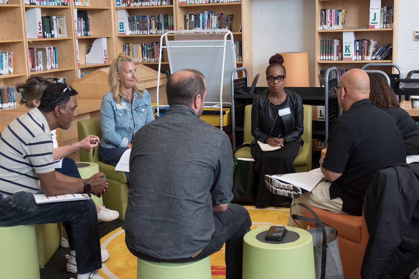 Staff seated in circle speaking to one another