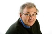 Multi award-winning communicator and storyteller David Grossman smiling while looking up at the camera.