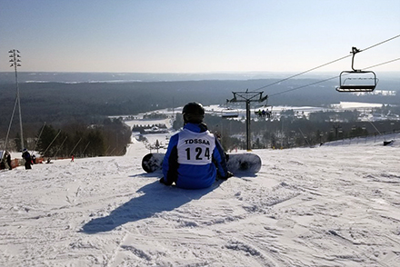 An athlete is about to snowboard